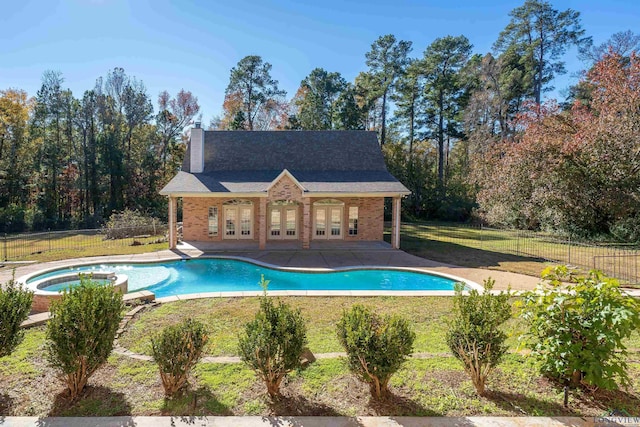 view of swimming pool with a yard and an in ground hot tub