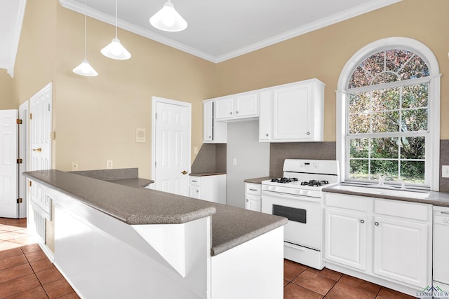 kitchen with white cabinetry, backsplash, dark tile patterned floors, and white appliances