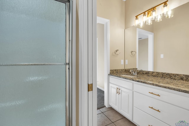 bathroom with tile patterned flooring and vanity