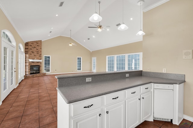 kitchen with ceiling fan, dark tile patterned flooring, a fireplace, white cabinetry, and high vaulted ceiling