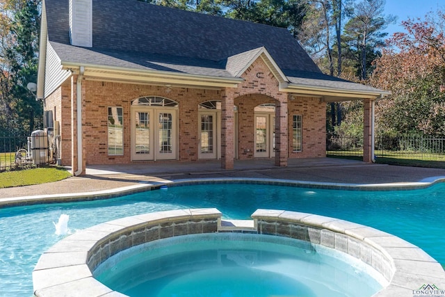 view of swimming pool with a patio and an in ground hot tub