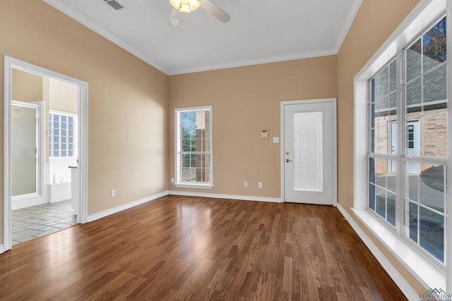 empty room featuring ceiling fan, dark wood-type flooring, and crown molding