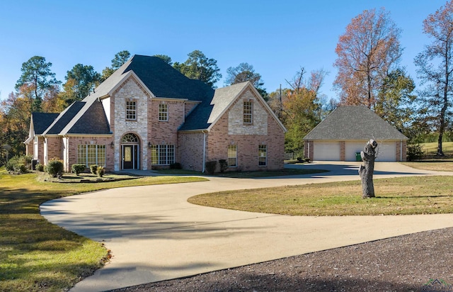 view of front of home with a garage and a front lawn