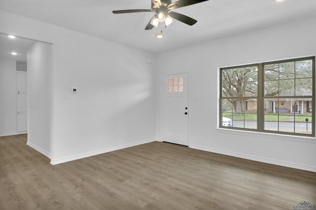 unfurnished room with hardwood / wood-style floors, a wealth of natural light, and ceiling fan