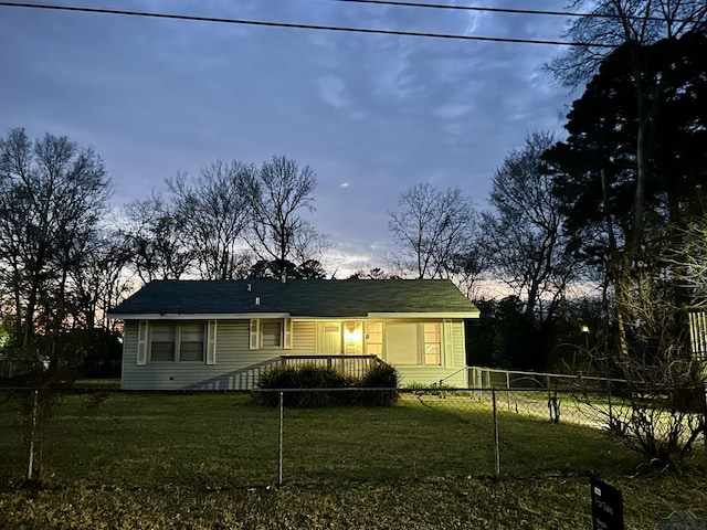 view of front of house with a fenced front yard and a front lawn