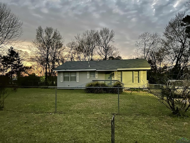 view of front facade featuring fence and a front lawn