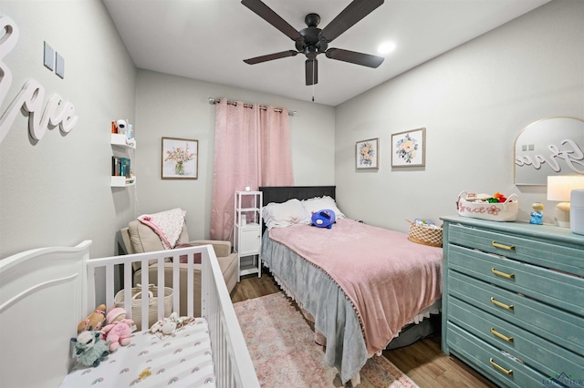 bedroom featuring ceiling fan and hardwood / wood-style flooring