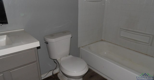 full bathroom with vanity, tiled shower / bath, and toilet