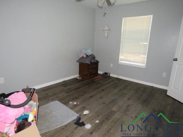 spare room with ceiling fan and dark hardwood / wood-style floors