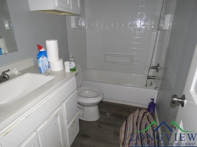 full bathroom featuring hardwood / wood-style floors, vanity, toilet, and shower / bathing tub combination