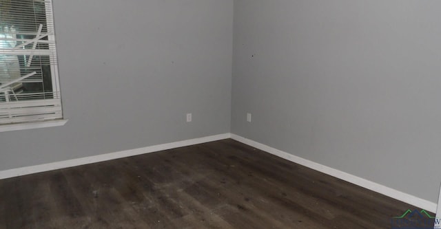 empty room with dark hardwood / wood-style floors