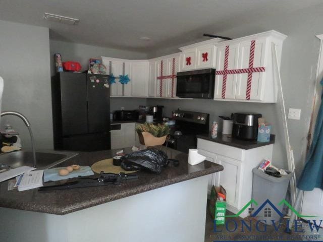 kitchen with kitchen peninsula, white cabinetry, sink, and black appliances