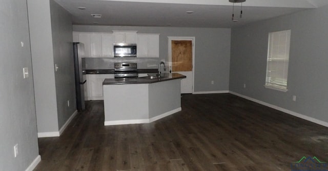 kitchen with white cabinetry, appliances with stainless steel finishes, and dark hardwood / wood-style floors