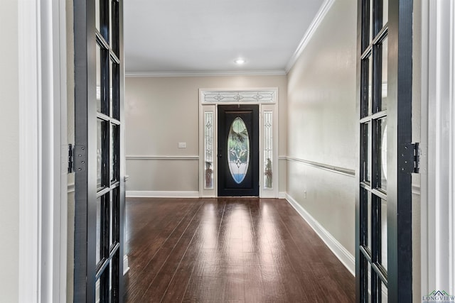 foyer entrance with dark hardwood / wood-style flooring and ornamental molding