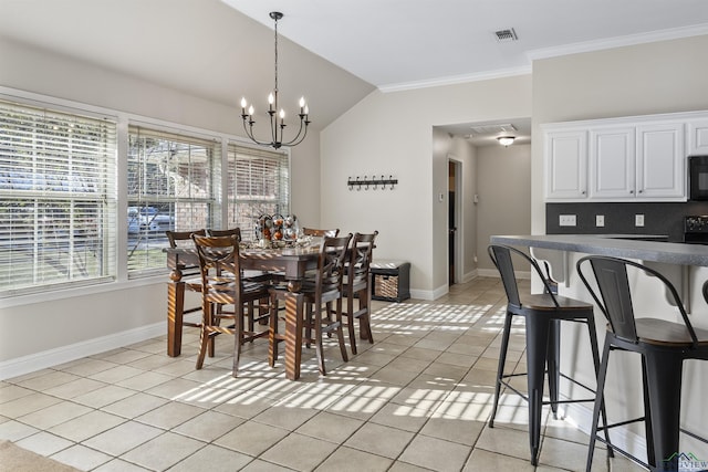 dining area with light tile patterned flooring, ornamental molding, lofted ceiling, and a notable chandelier