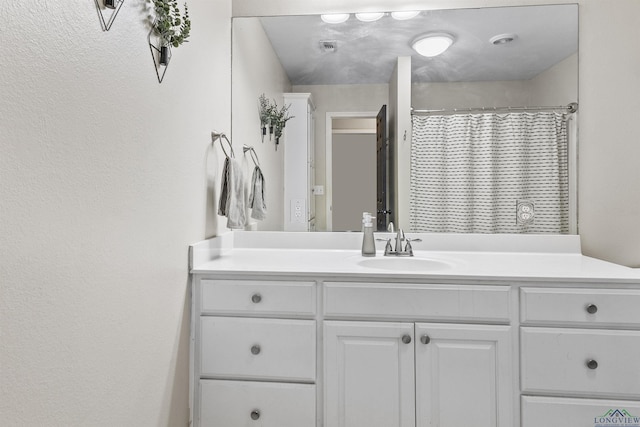 bathroom with a shower with shower curtain and vanity