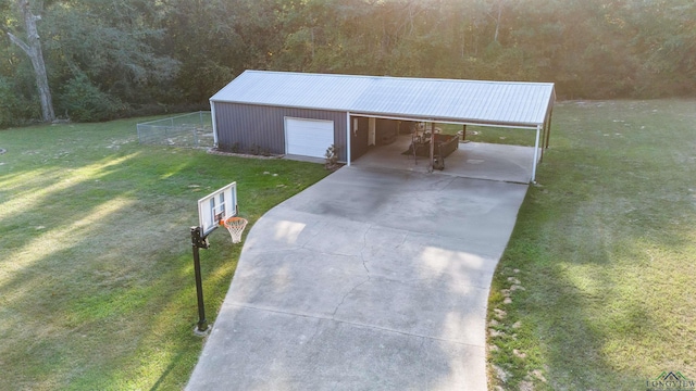 exterior space featuring a garage, a carport, and an outdoor structure