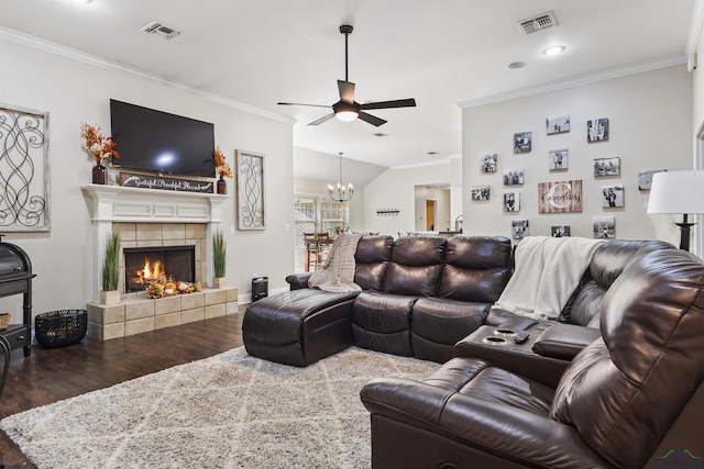 living room featuring hardwood / wood-style flooring, a fireplace, crown molding, and ceiling fan with notable chandelier