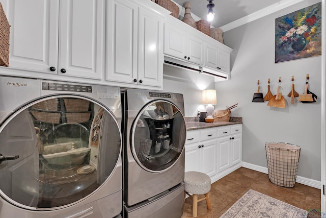 washroom featuring light tile patterned flooring, cabinets, ornamental molding, and washing machine and clothes dryer