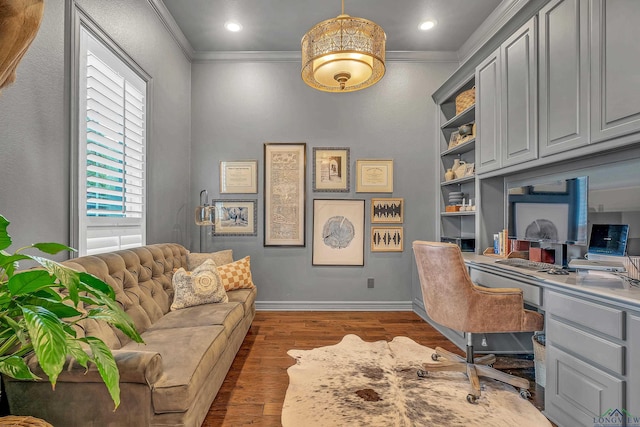 office featuring dark hardwood / wood-style flooring, built in desk, and ornamental molding