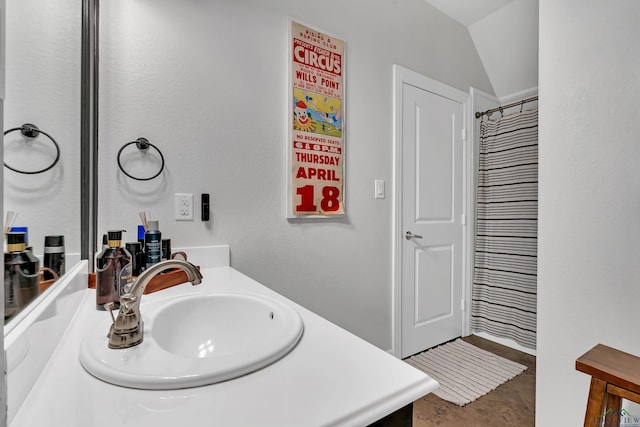 bathroom with vanity and vaulted ceiling