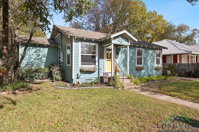 view of front of house with a front lawn, crawl space, and fence