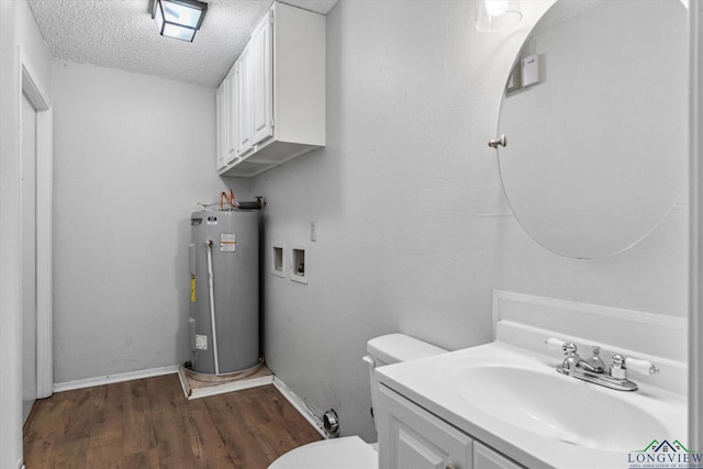 204 Half St, Lindale, TX 75771 - bathroom featuring water heater, wood finished floors, a textured ceiling, toilet, and vanity