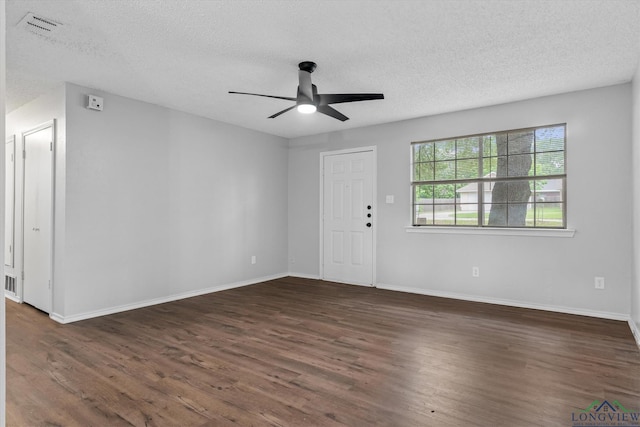 204 Half St, Lindale, TX 75771 - foyer entrance featuring ceiling fan, a textured ceiling, dark wood-type flooring, and baseboards