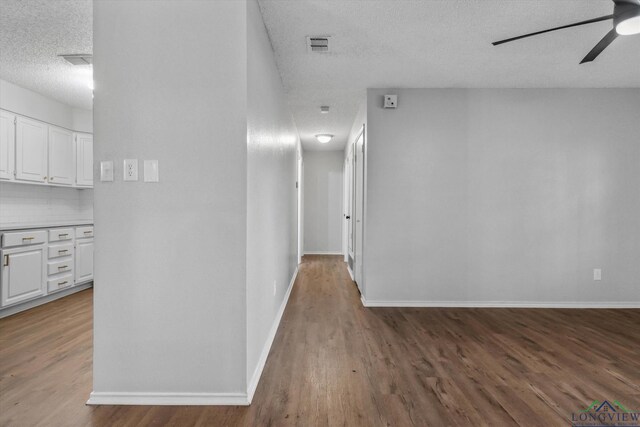 204 Half St, Lindale, TX 75771 - hallway with a textured ceiling, wood finished floors, and baseboards