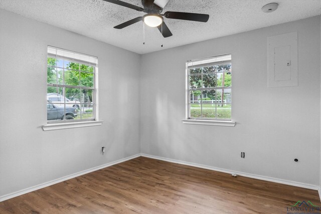 204 Half St, Lindale, TX 75771 - unfurnished room with baseboards, wood finished floors, a textured ceiling, electric panel, and a ceiling fan