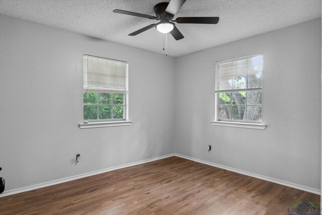 204 Half St, Lindale, TX 75771 - unfurnished room with wood finished floors, ceiling fan, baseboards, and a textured ceiling