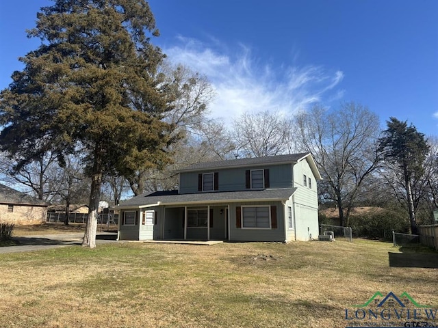 view of front of property featuring a front yard and central AC