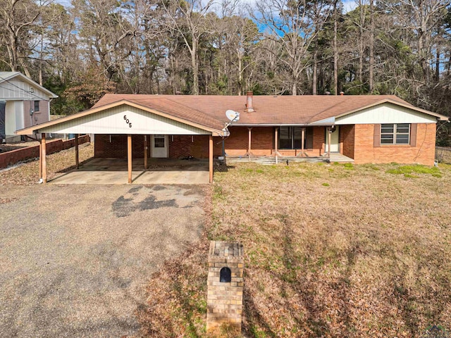 view of front of property with a front yard, covered porch, and a carport