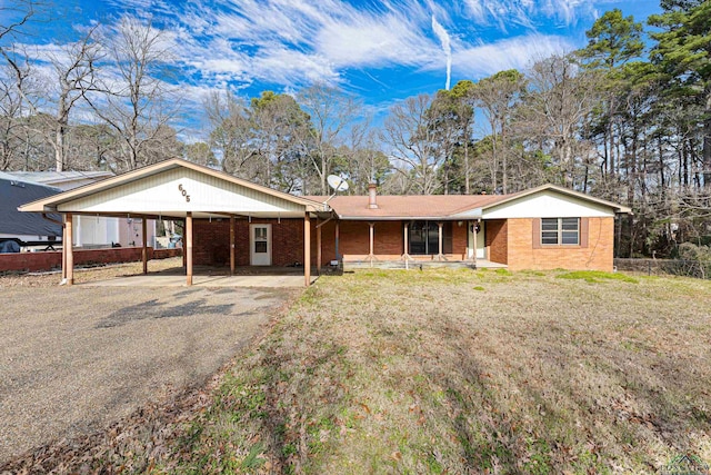 single story home with a front yard and a carport