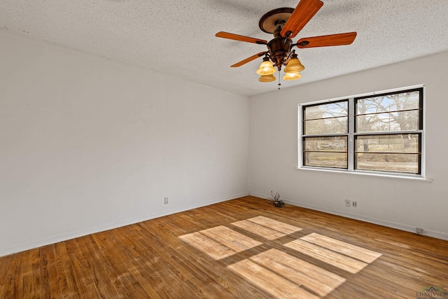 unfurnished room featuring a textured ceiling, ceiling fan, and light hardwood / wood-style flooring