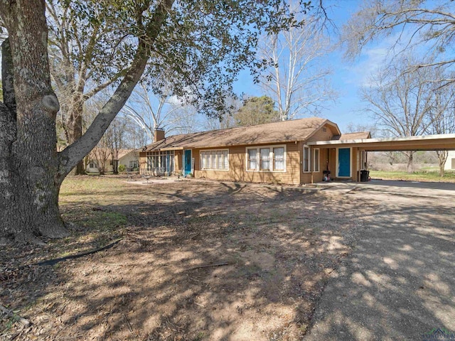 ranch-style house featuring a carport