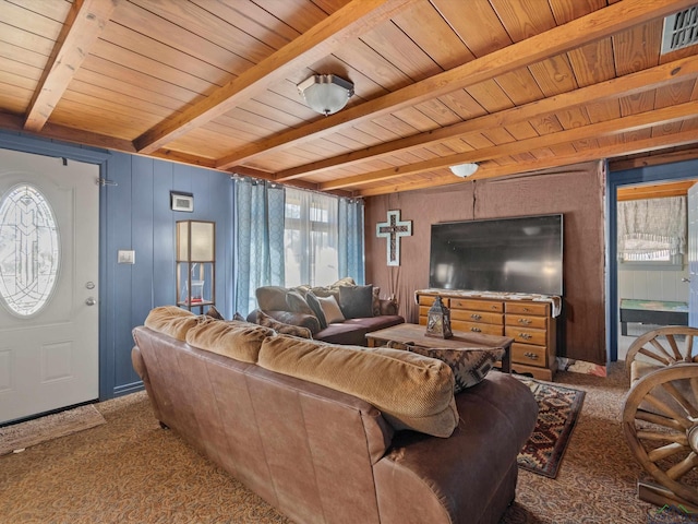 living room with beam ceiling, carpet floors, and wooden walls