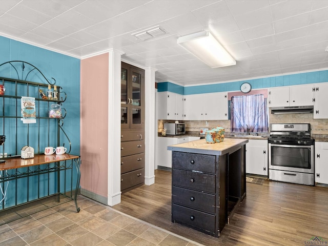 kitchen featuring a center island, sink, stainless steel appliances, tasteful backsplash, and white cabinets