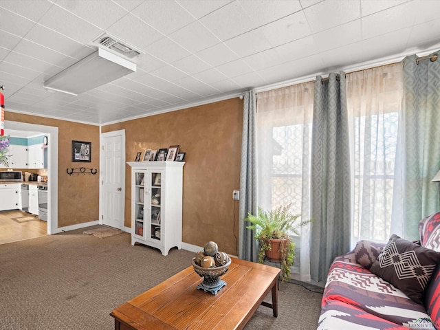 carpeted living room featuring crown molding