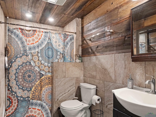 bathroom featuring wooden ceiling, walk in shower, toilet, vanity, and tile walls