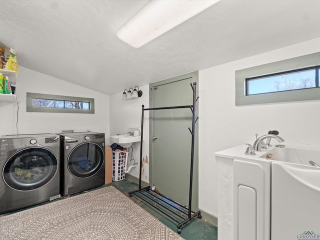 laundry area with separate washer and dryer and sink