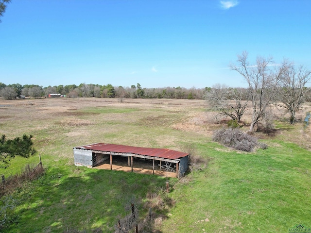 view of yard with an outbuilding and a rural view