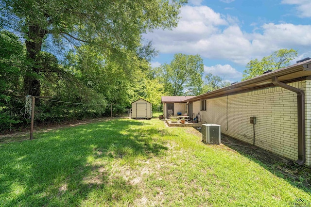 207 E Eleanor St, Gladewater, TX 75647 - view of grassy yard with a storage unit