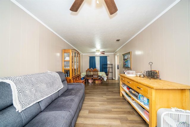 207 E Eleanor St, Gladewater, TX 75647 - living room featuring ceiling fan, light wood-type flooring, and crown molding