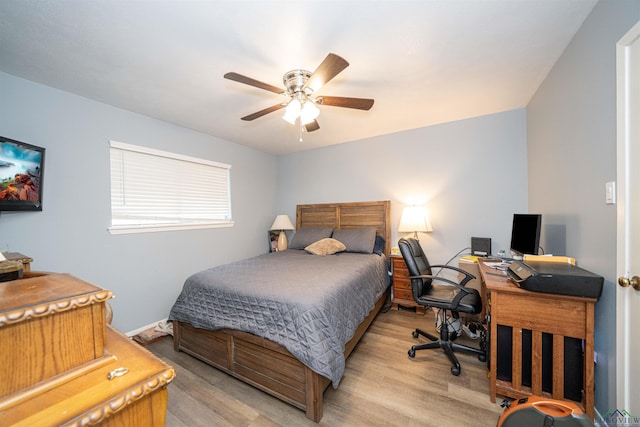 207 E Eleanor St, Gladewater, TX 75647 - bedroom with light wood-type flooring, a desk, and a ceiling fan