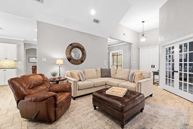 1844 Raven Rd, Diana, TX 75640 - living area featuring stone tile floors, arched walkways, recessed lighting, ornamental molding, and french doors