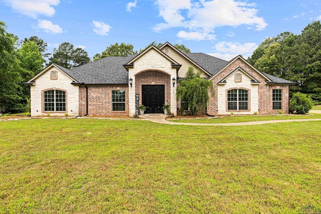 1844 Raven Rd, Diana, TX 75640 - view of front of home with a shingled roof, brick siding, a front lawn, and stone siding