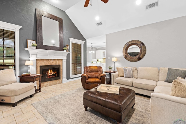 1844 Raven Rd, Diana, TX 75640 - living area with a tile fireplace, ceiling fan, stone tile flooring, recessed lighting, and high vaulted ceiling