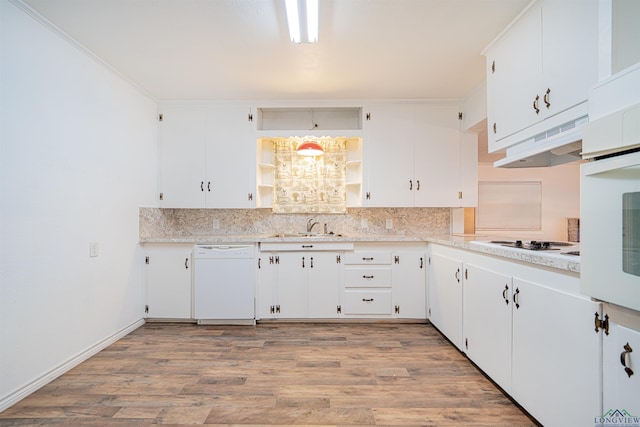 kitchen with light wood-type flooring, backsplash, white appliances, sink, and white cabinets