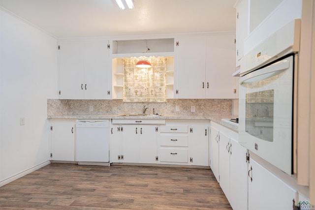 kitchen with white cabinets, dark hardwood / wood-style floors, and white appliances